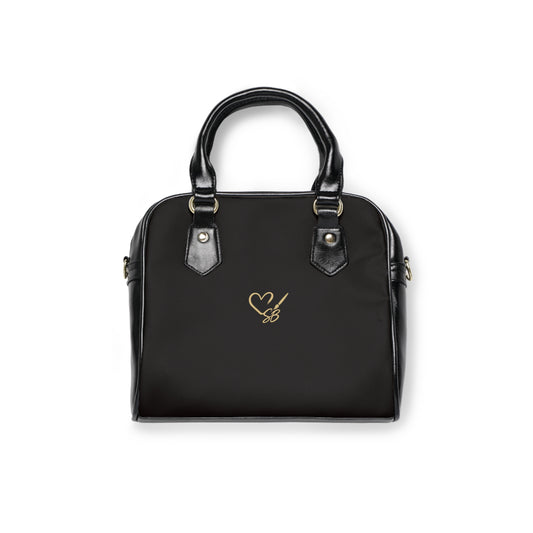 Black back of The Gilded Queen shoulder handbag with the Soulful Brush heart-and-brush logo.