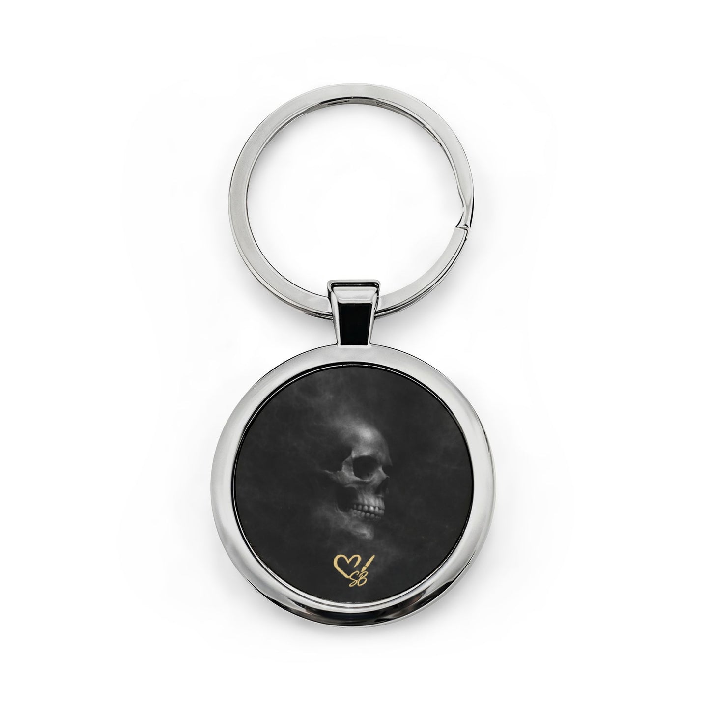 Llavero Veiled Remains Calavera — Llavero redondo de acero inoxidable con calavera ahumada y acento de corazón dorado