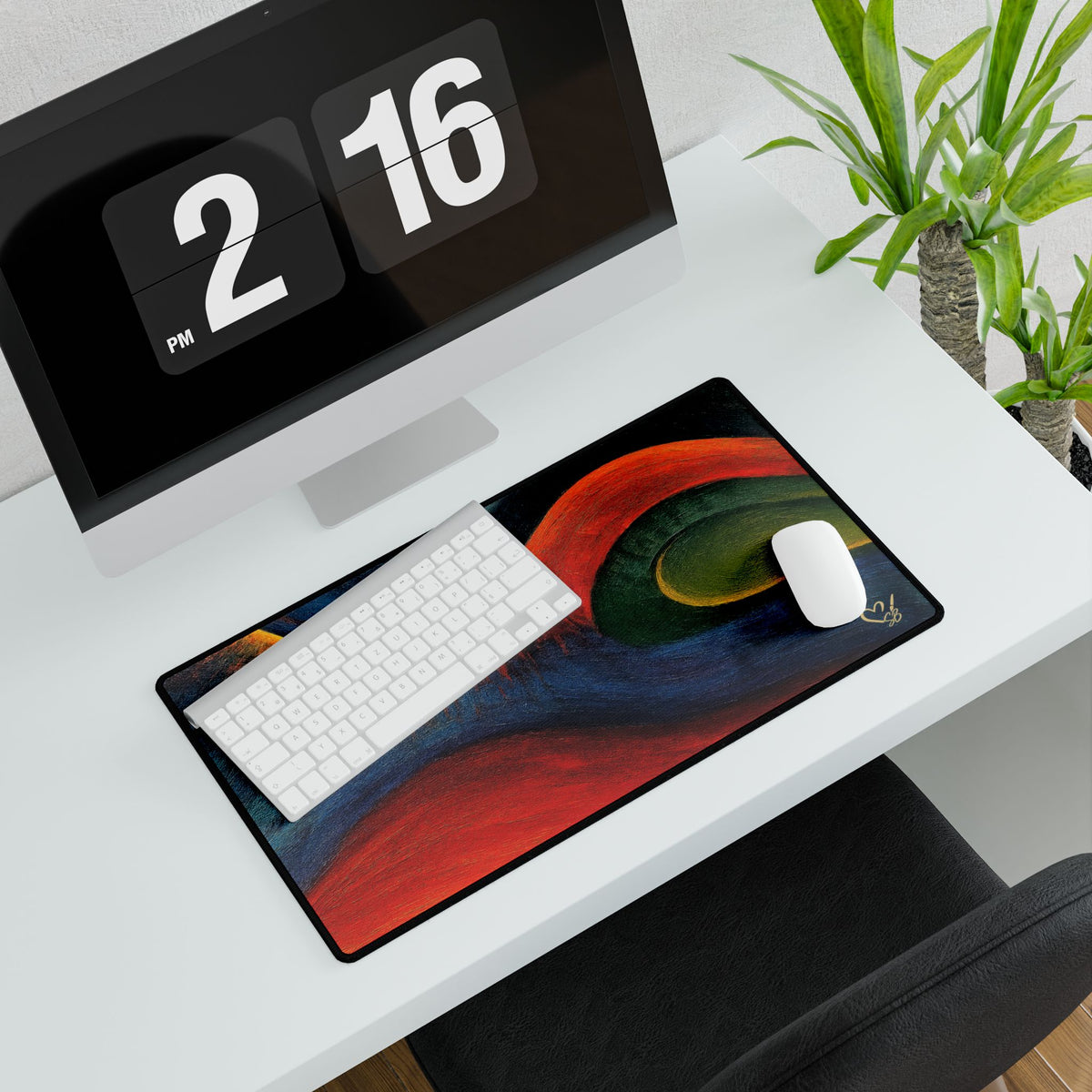 Rectangular abstract desk mat beneath a white keyboard and mouse on a white desk.
