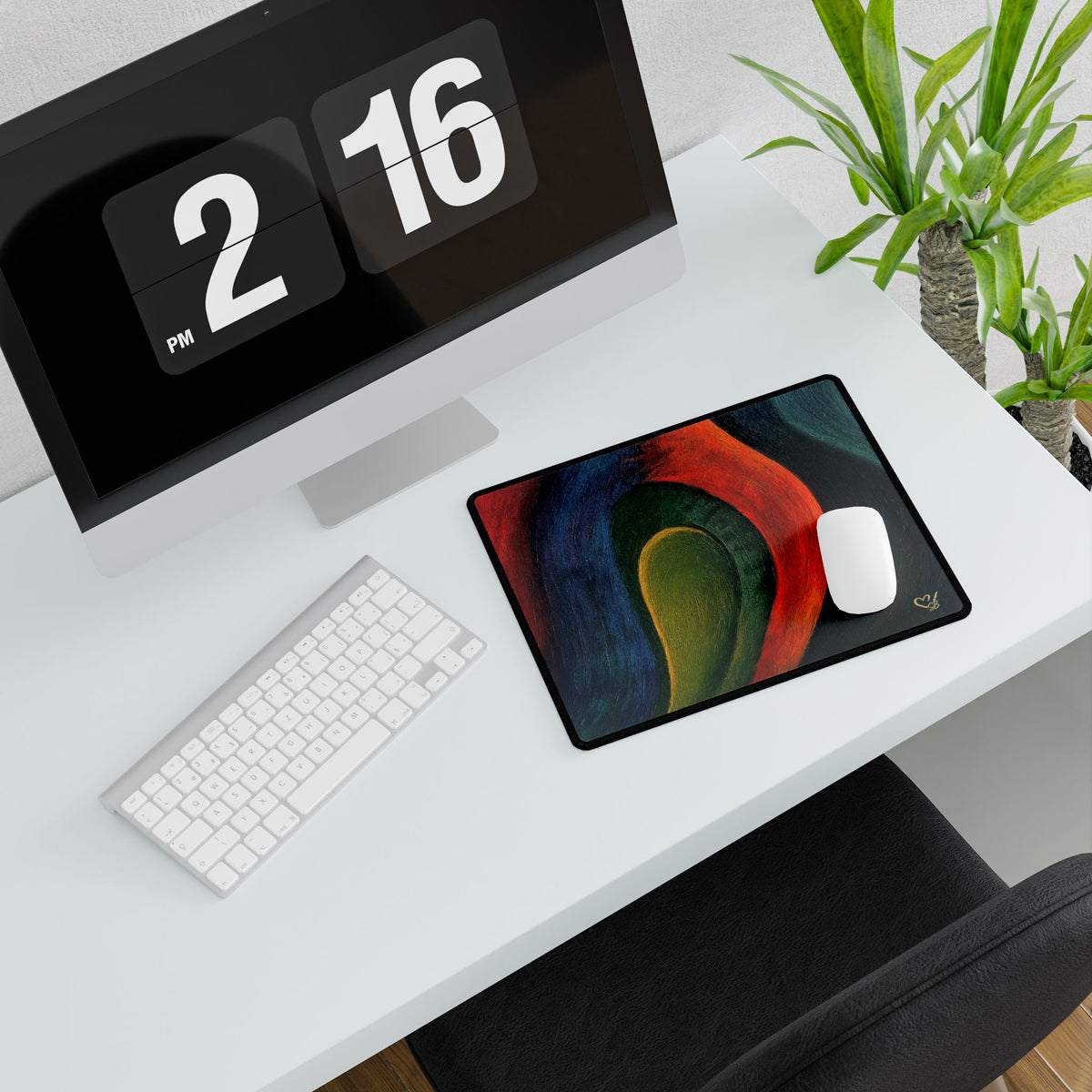 Compact abstract desk mat with a white mouse beside a keyboard and monitor.