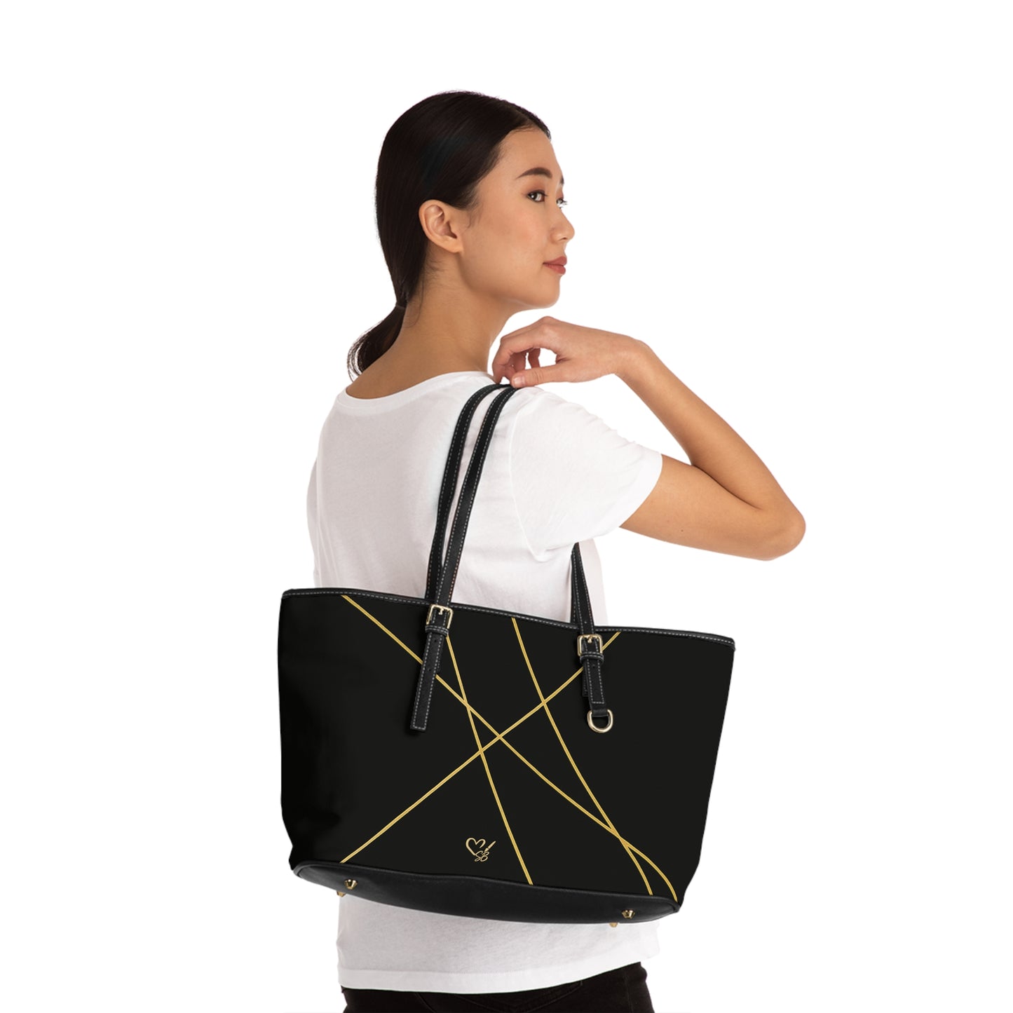 Michelle PU leather tote bag 17x11 worn on person – minimalist black gold line shoulder handbag by the Soulful Brush

