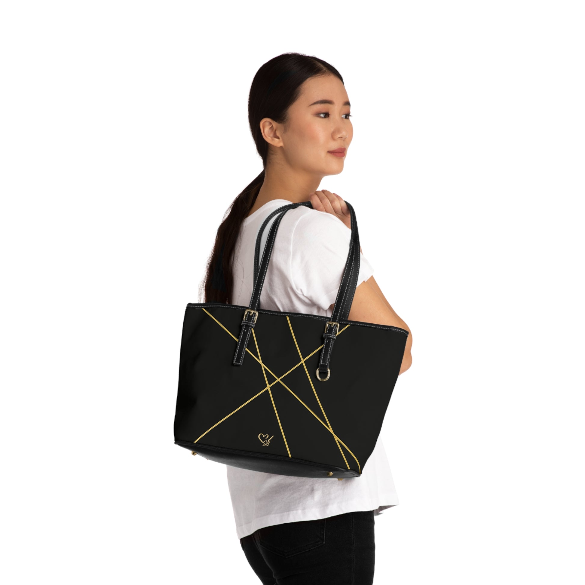 Michelle PU leather tote bag 16x10 worn on person – minimalist black gold line shoulder handbag by the Soulful Brush
