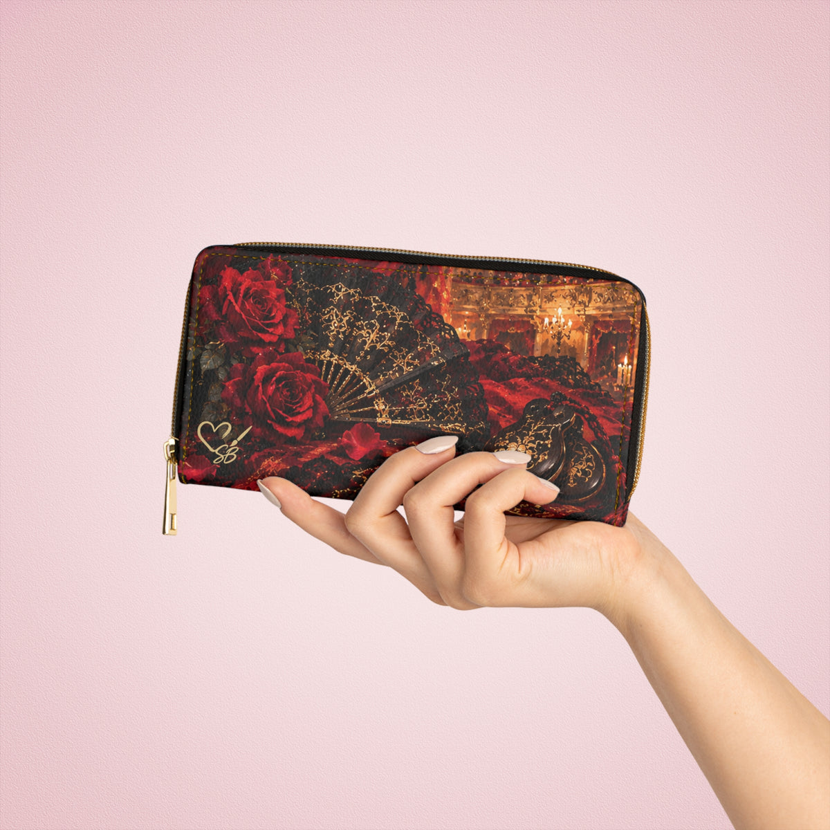 Carmen — The Last Note zipper wallet held in one hand against a pink background, showing red roses, a black and gold fan and castanets.