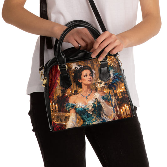 Model carrying The Masquerade — A Venetian Dream shoulder handbag, showing the portrait print, black handles and shoulder strap.