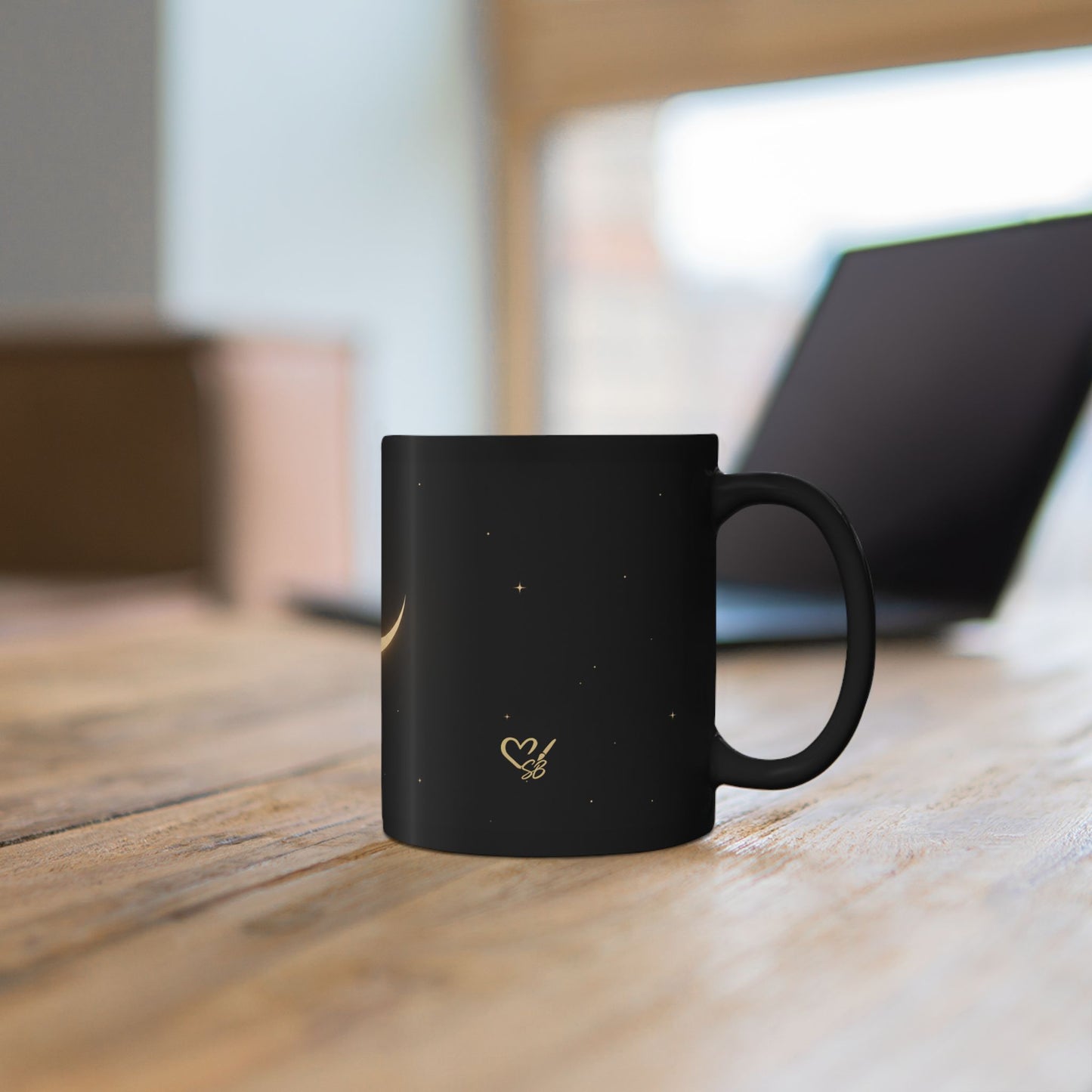 Lunar Veil black ceramic mug side view – glowing gold crescent moon and stars design by the Soulful Brush
